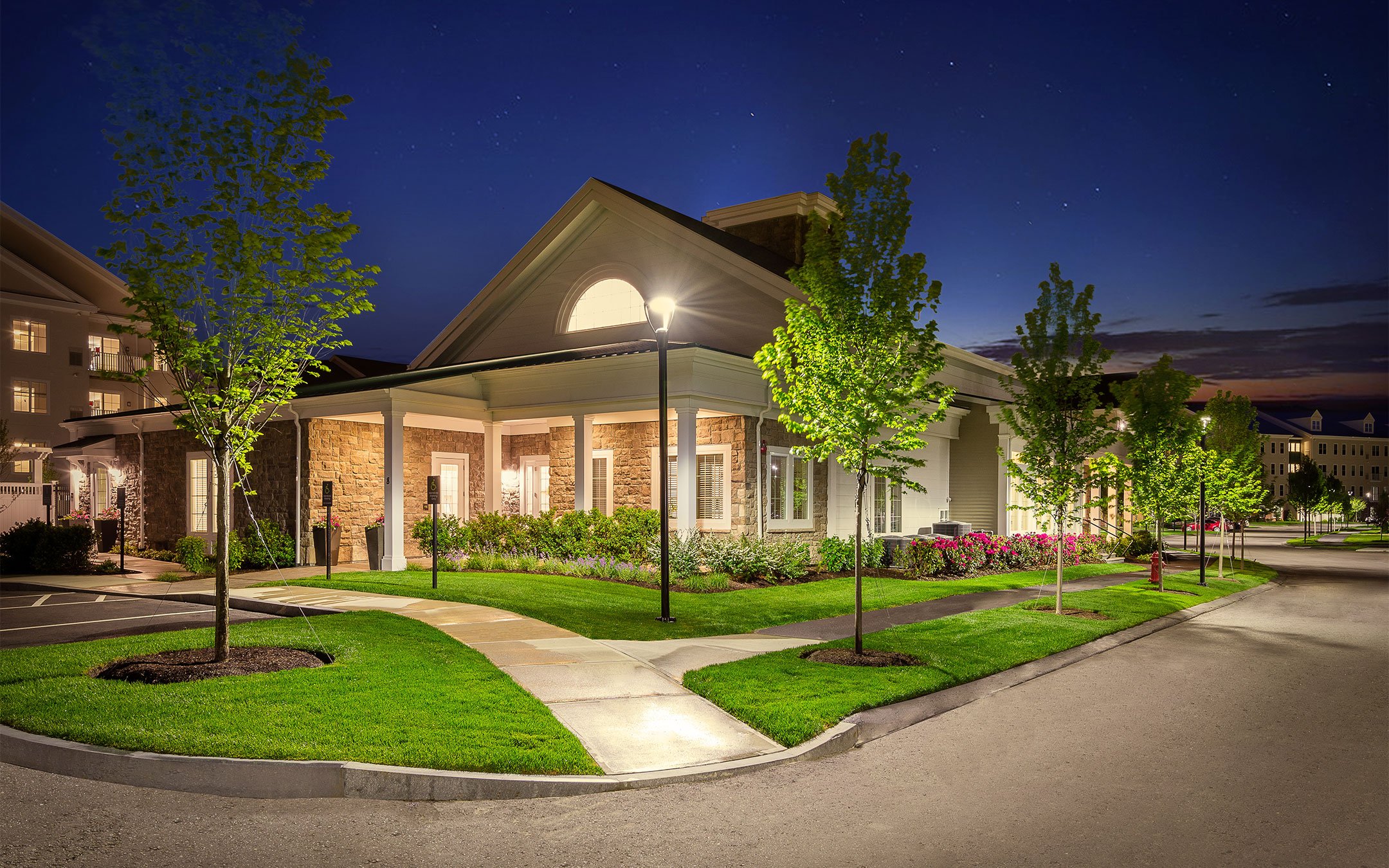 Stone clubhouse entrance at 1 Upland apartments on the former Polaroid campus in Norwood MA