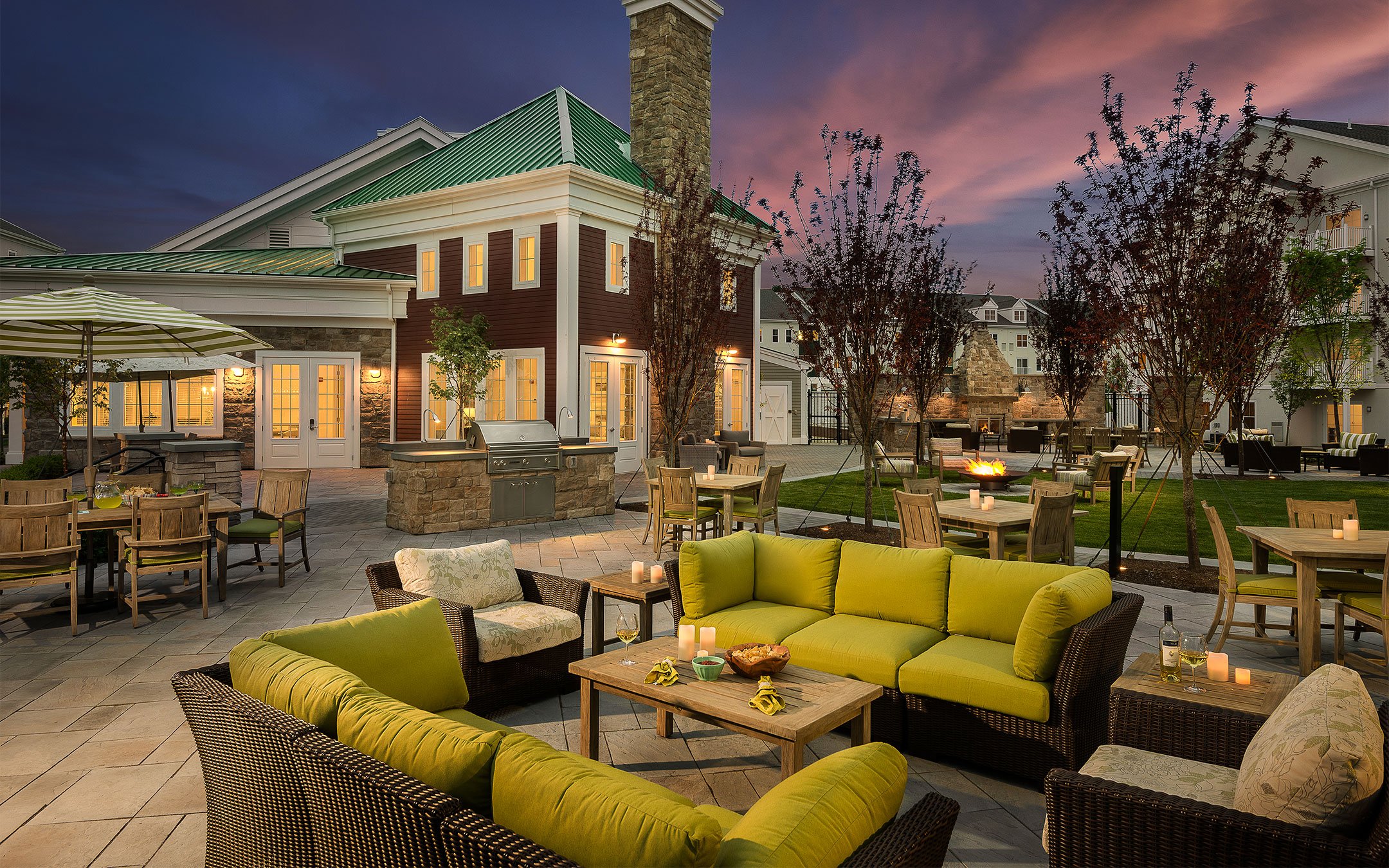 Outdoor patio with fire pit and grilling station at 1 Upland apartments in Norwood MA