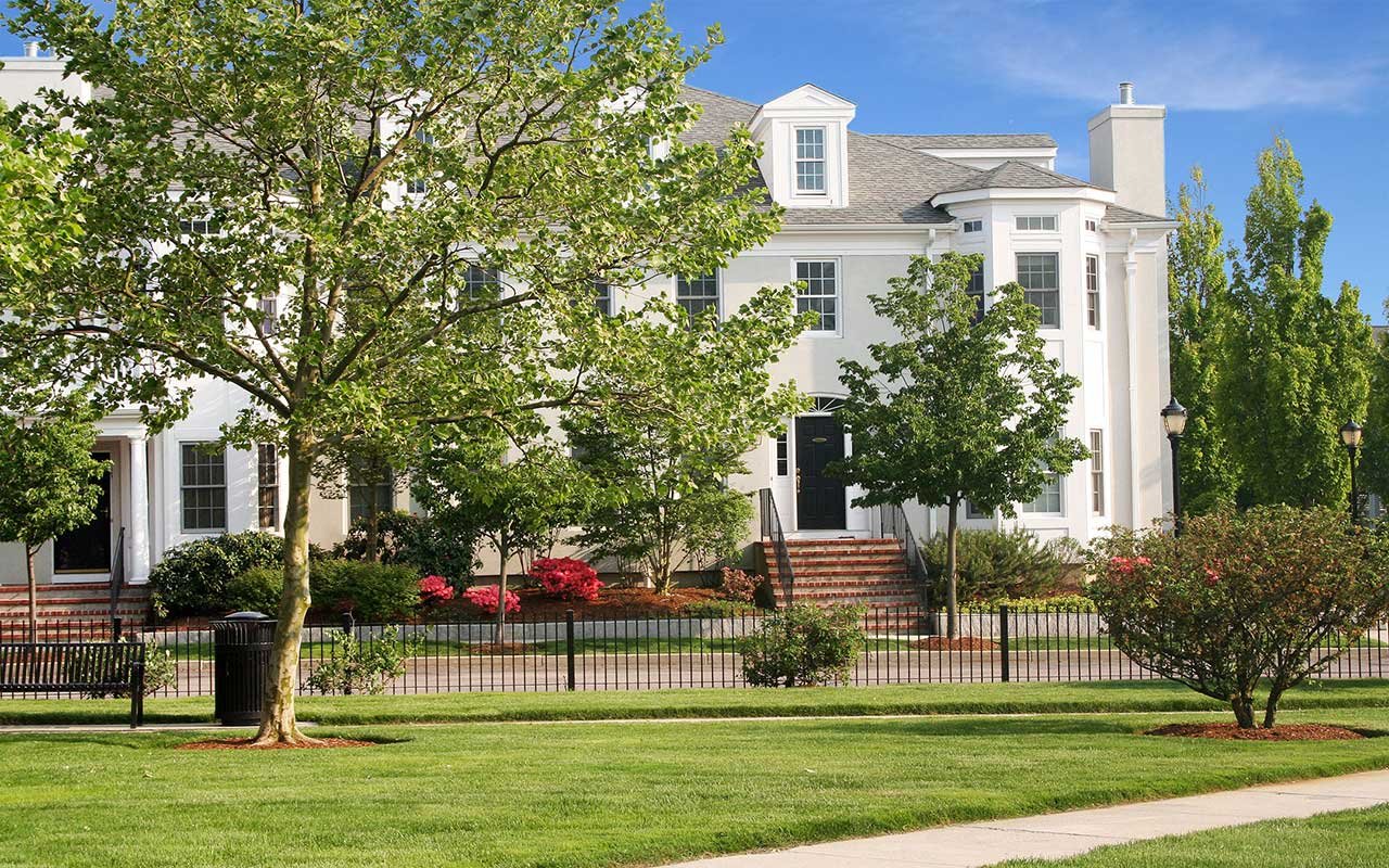 Condominium building and open green at Chapman's Reach, an award-winning new home community at Marina Bay Quincy MA