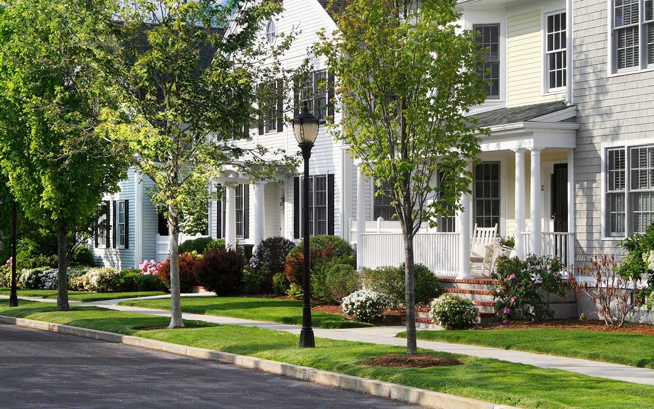Front-porch single-family homes along a tree-lined street at Chapman's Reach, Thorndike's award-winning community in Quincy MA