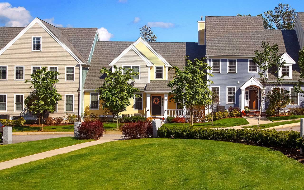 Central green and exterior of Building 75 at WestRidge, Thorndike's 55+ active adult community in Hudson MA
