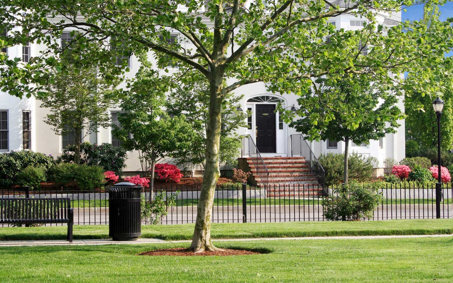 Award-winning Chapman's Reach condominiums at Marina Bay in Quincy MA, with classic brick entry steps and blooming azaleas