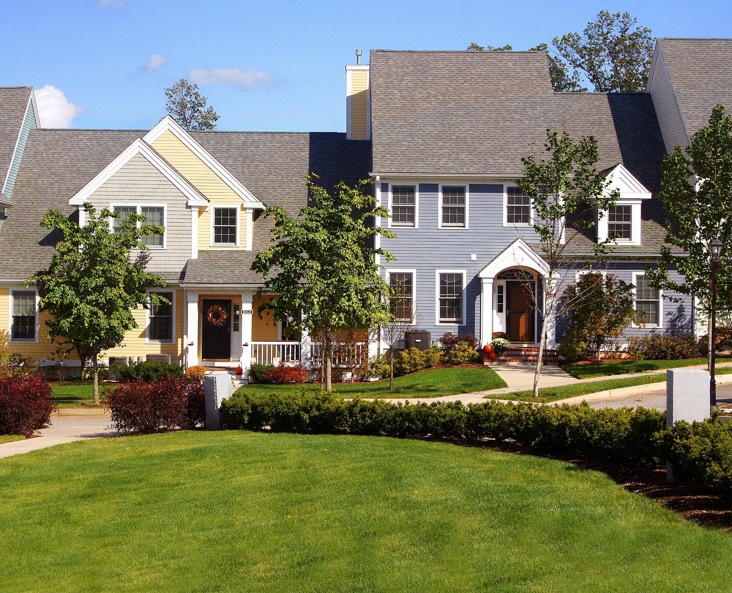Central green and exterior of Building 75 at WestRidge, Thorndike's 55+ active adult community in Hudson MA