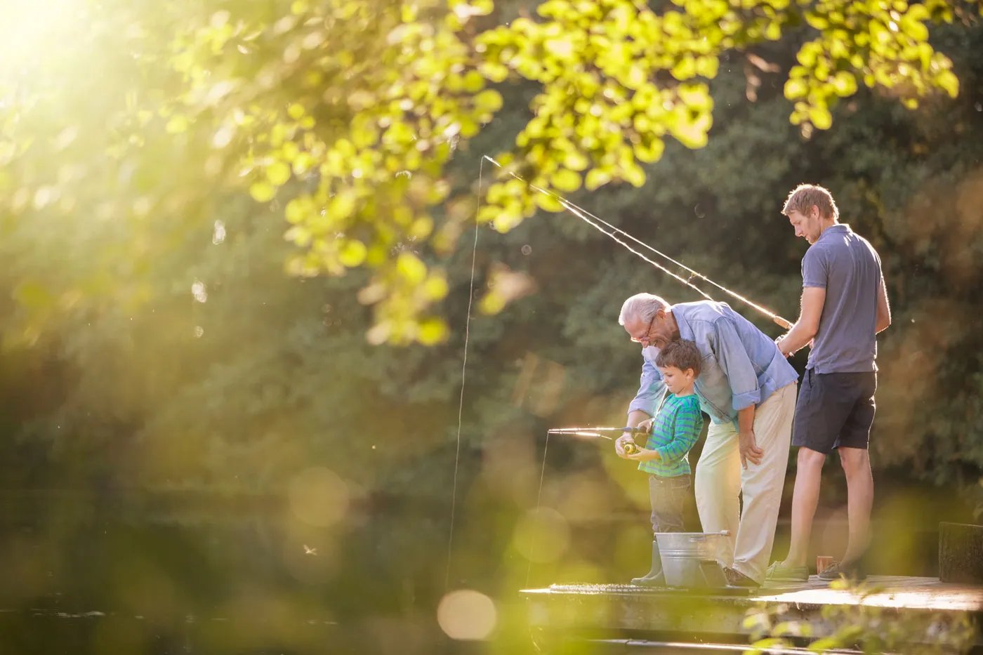 Family fishing on a dock near Featherwinds 55+ condominiums in Halifax MA