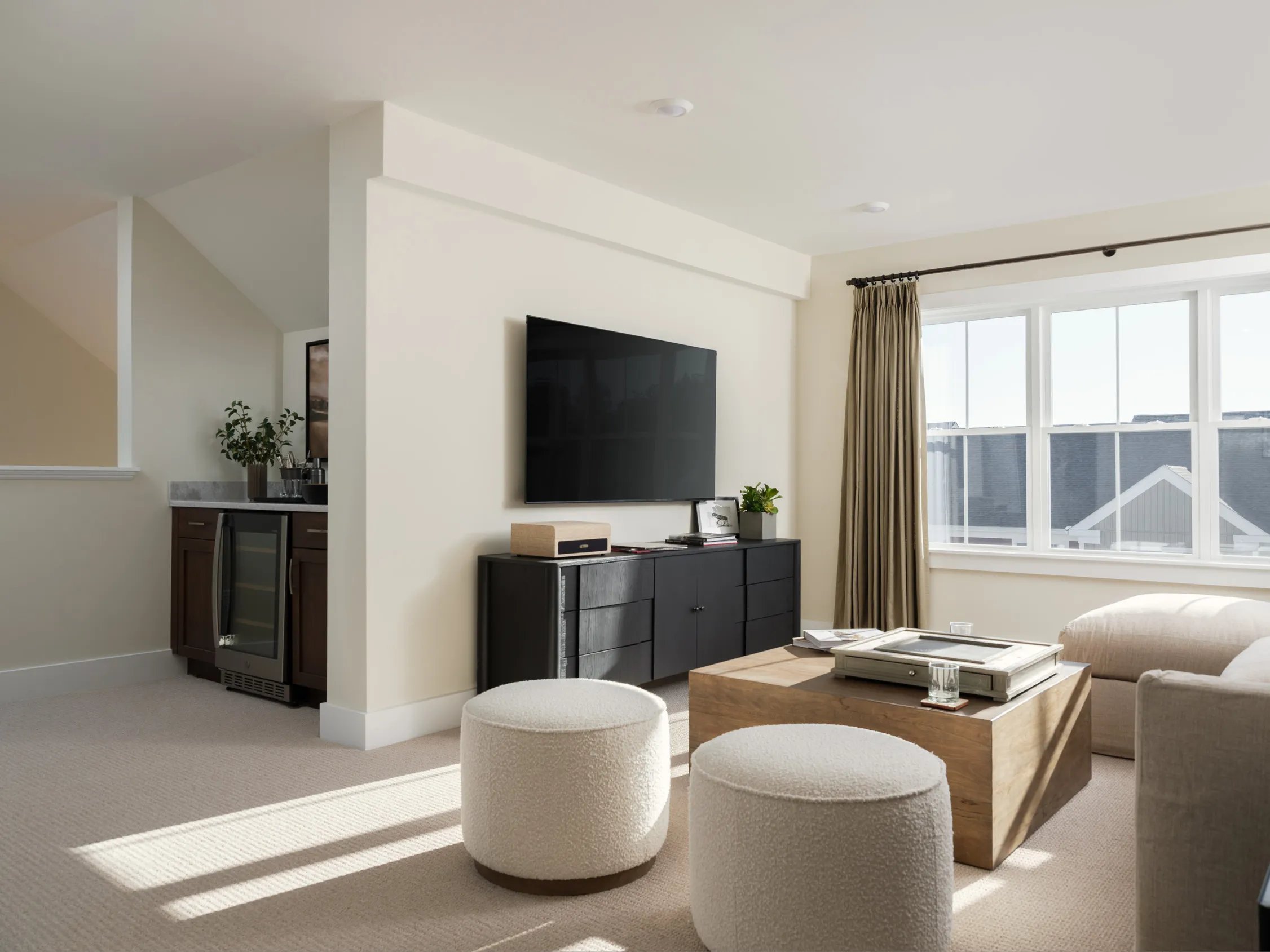 Loft media room with wall-mounted TV and dry bar at Alden's Reach condos in Plymouth MA
