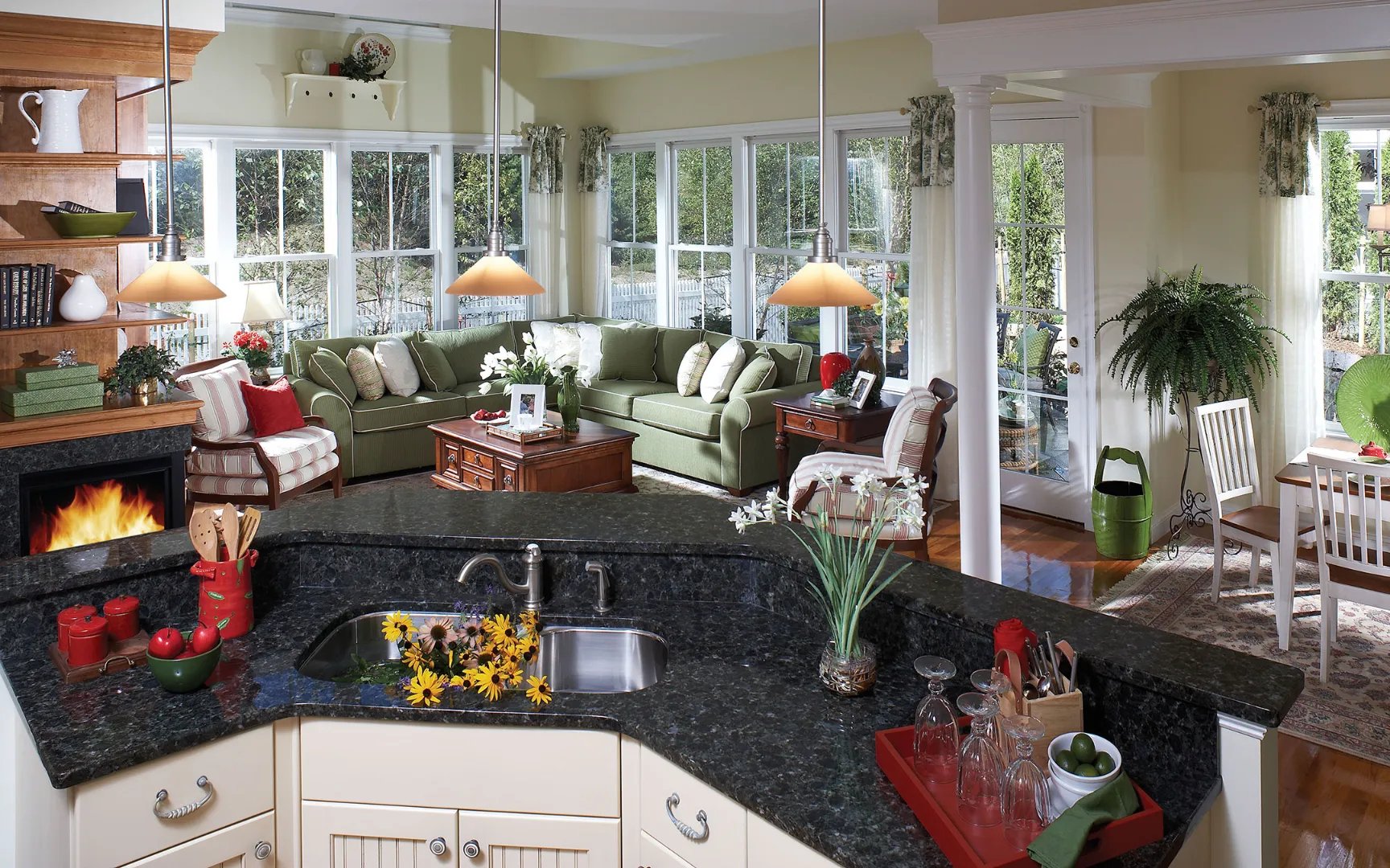 Sunlit conservatory with fireplace in a Red Mill Village active adult home, Norton MA