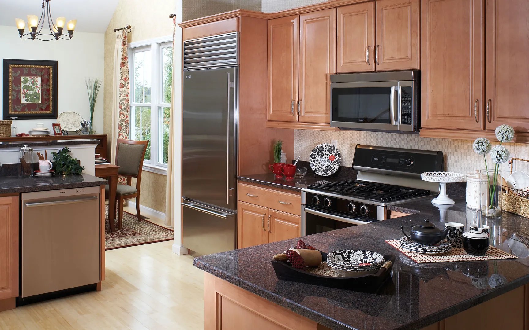 Modern kitchen with cherry cabinetry and stainless appliances at Red Mill Village, Norton MA