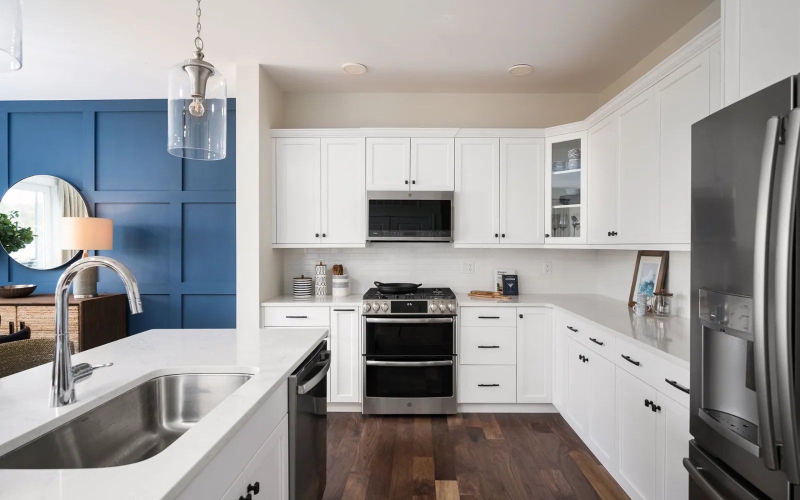 White kitchen with stainless appliances and quartz counters in Sawyer's Reach condo Plymouth MA