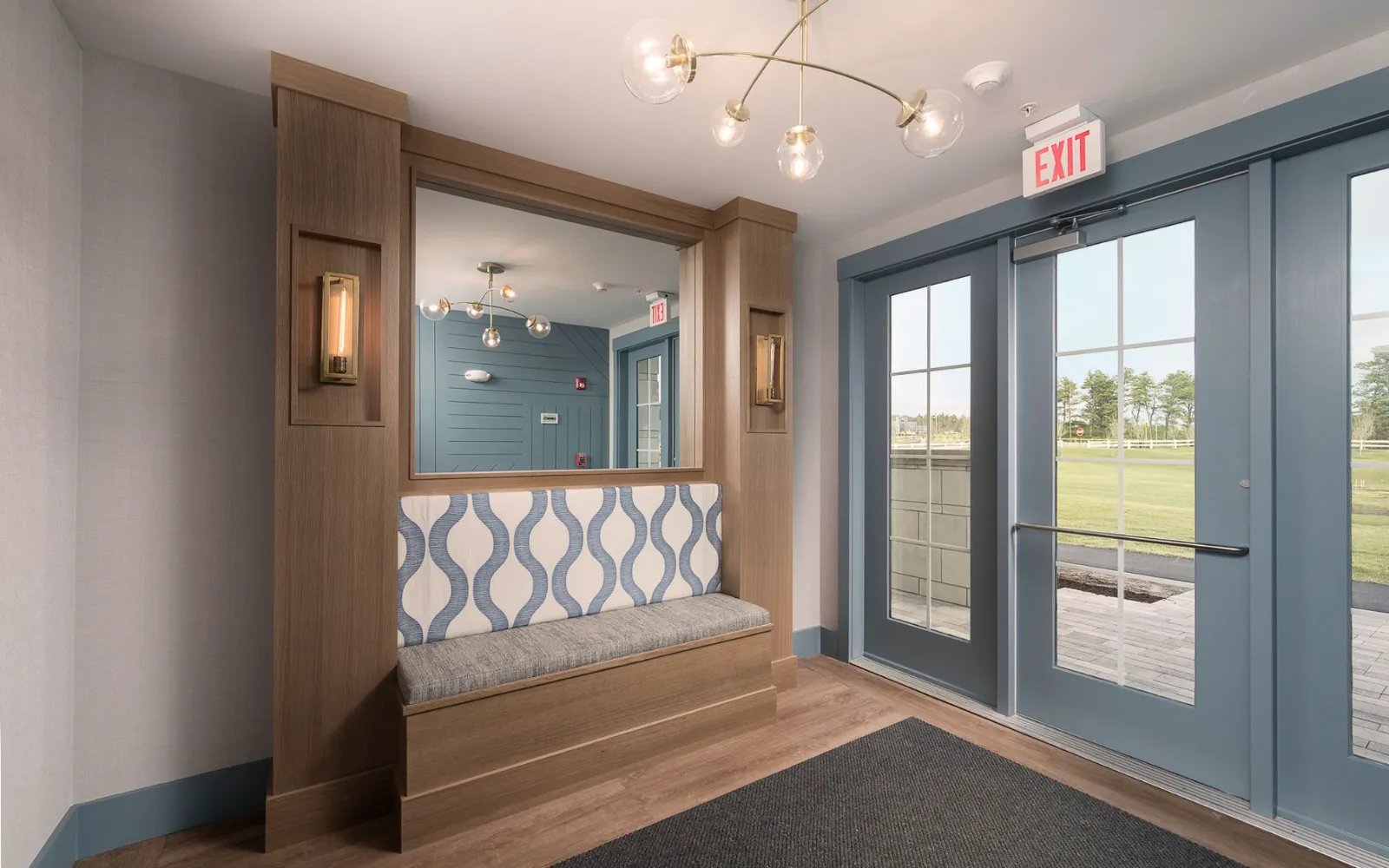 Stylish entry vestibule with tile accent and seating in Sawyer's Reach condo Plymouth MA
