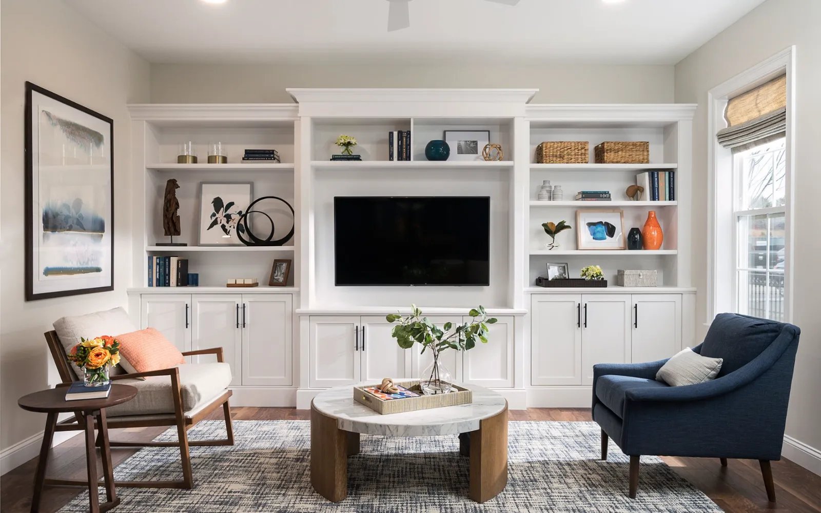 Family room with custom built-ins and TV wall in Sawyer's Reach active adult home Plymouth MA