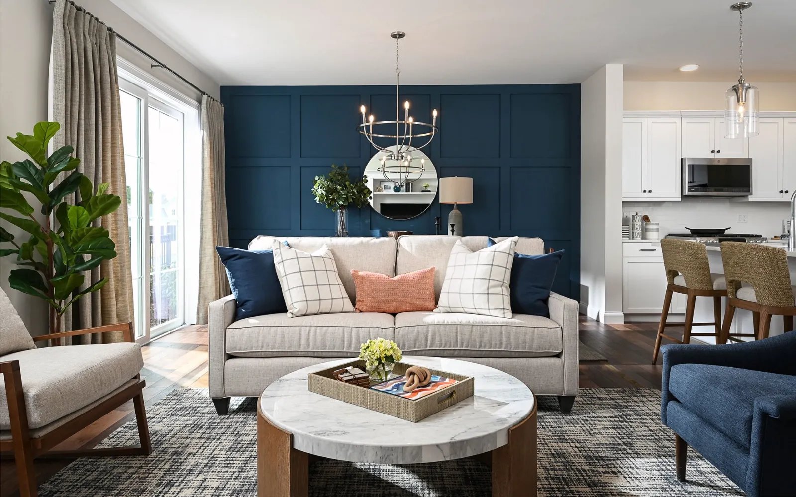 Open-concept living room with blue feature wall in Sawyer's Reach model unit Plymouth MA