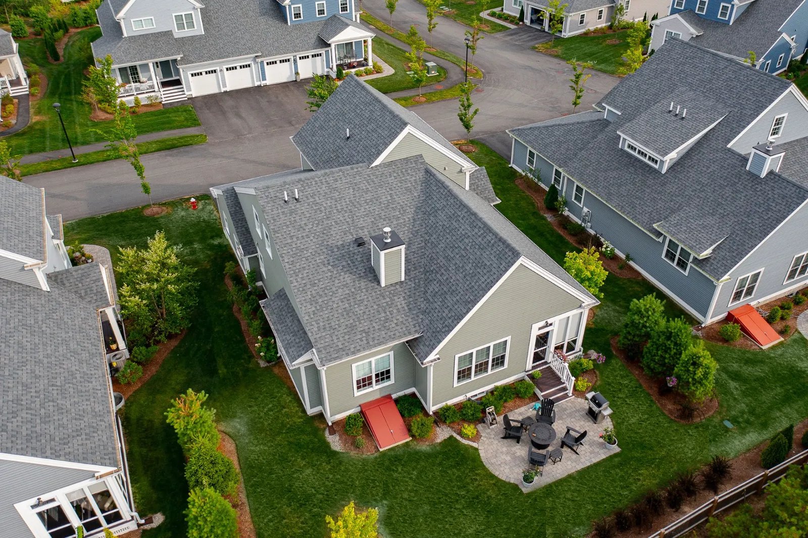 Drone view of Sawyer's Reach townhomes showing backyards and patios in Plymouth MA