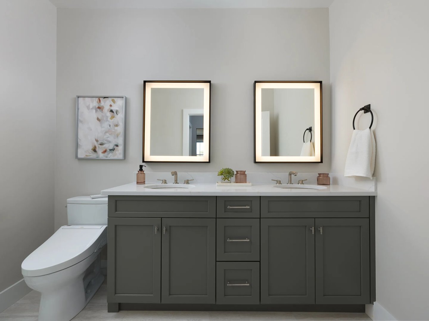 Primary bath with double vanity and lighted mirrors at Alden's Reach condos in Plymouth MA