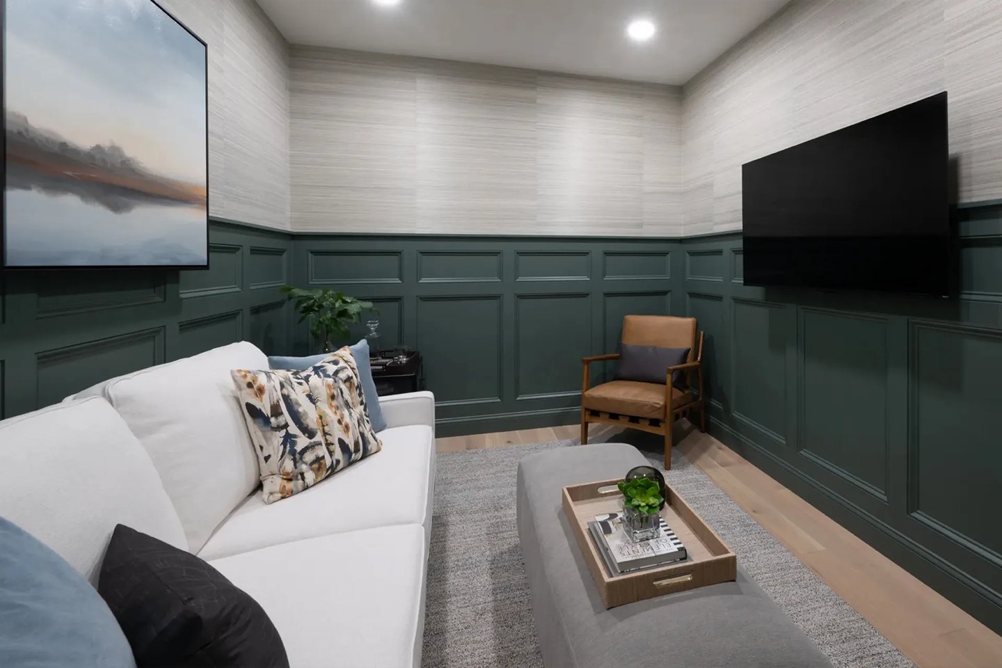 Den with forest green wainscoting and built-in media wall in a Featherwinds 55+ condo in Halifax MA