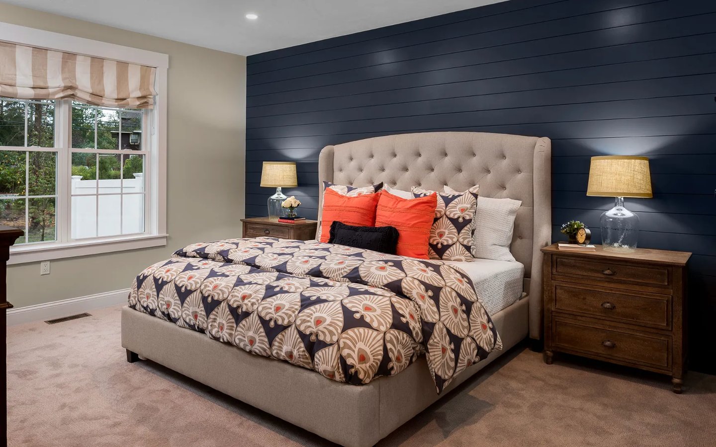 Elegant master bedroom with navy accent wall at Summer Reach active adult home in Plymouth MA