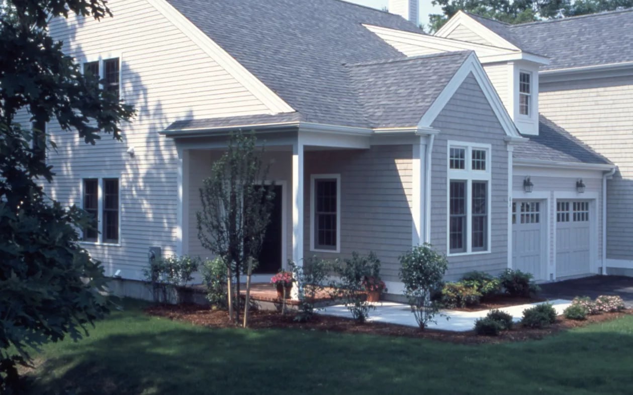 Home exterior with raised garden beds and private deck at GreatBrook Norton Massachusetts